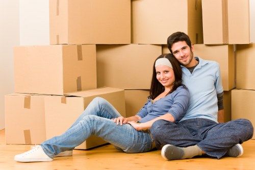 Professional movers handling boxes and furniture for a student relocation