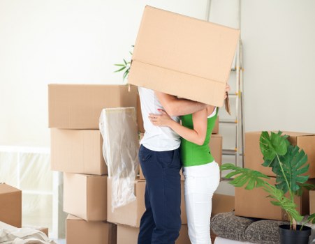 Packed moving boxes and furniture ready for transport in Egham