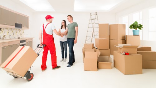 Packing furniture and boxes into a moving truck in Egham