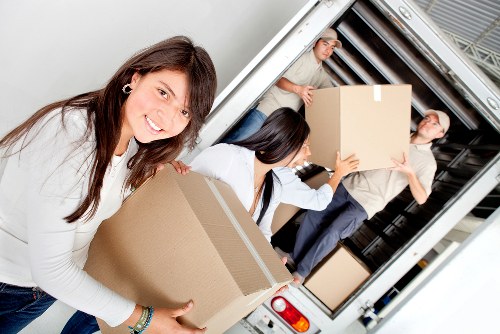 Movers handling furniture during a home relocation in Egham