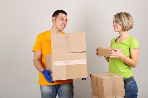 A removals team handling apartment furniture during a flat move in Egham
